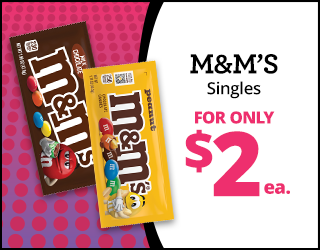 Two M&Ms candy packs, milk chocolate and peanut, on a pink polka dot background. Text reads: M&Ms Singles FOR ONLY $2 ea. in bold black and pink letters.